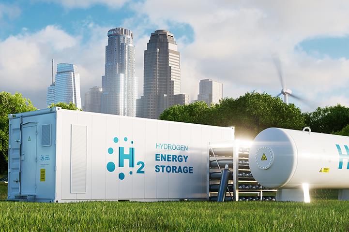 Hydrogen energy storage tanks under a cityscape and blue sky